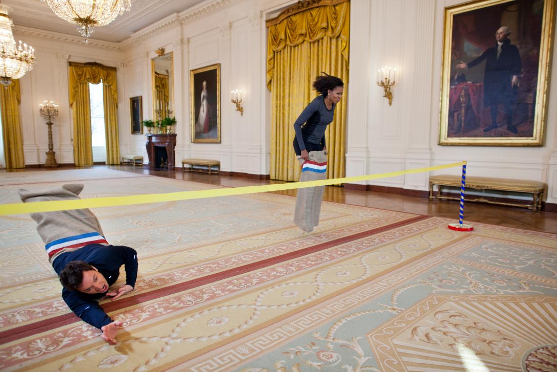 First Lady Michelle Obama participates in a potato sack race with Jimmy Fallon in the East Room of the White House during a “Late Night with Jimmy Fallon” taping for the second anniversary of the "Let’s Move!" initiative, January 25, 2012.