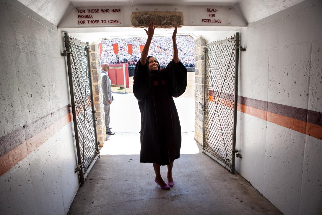 First Lady Michelle Obama touches the Hokie Stone before walking onto the field at Lane Stadium to give the Virginia Tech commencement address in Blacksburg, Virginia, May 11, 2012. 