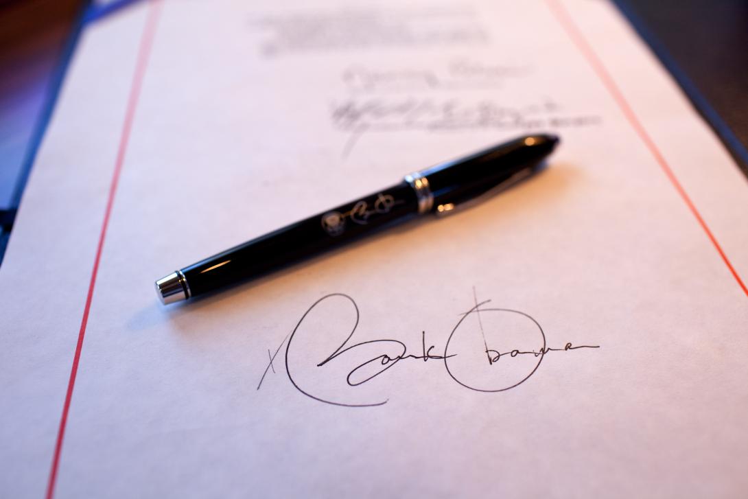 Close-up detail of President Obama's signature on the American Recovery and Reinvestment Act, and a pen used for the signing, aboard Air Force One on a flight from Buckley Air Force Base, Denver, Colorado to Phoenix, Arizona, February 17, 2009. 