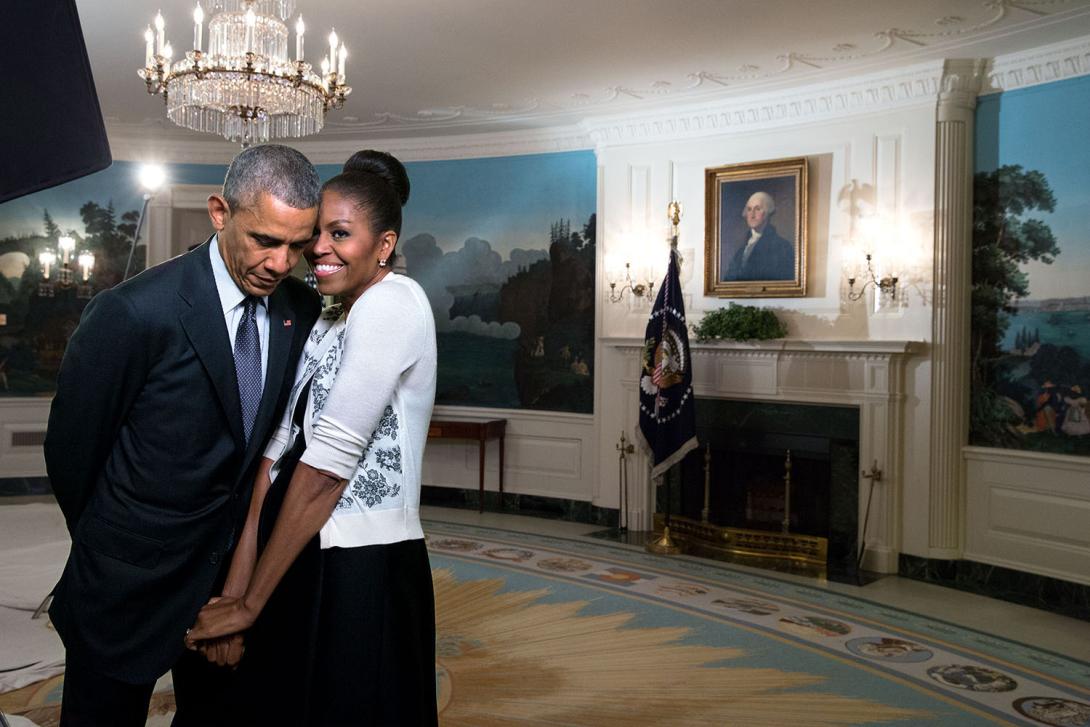 First Lady Michelle Obama snuggles against President Barack Obama before a videotaping for the 2015 World Expo, in the Diplomatic Reception Room of the White House, March 27, 2015. 