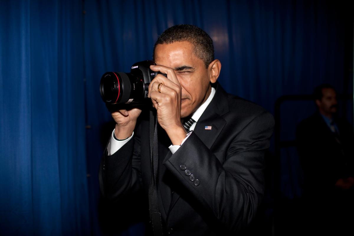 President Barack Obama takes aim with a photographer's camera backstage prior to remarks about providing mortgage payment relief for responsible homeowners at Dobson High School, Mesa, Arizona, February 18, 2009. (P021809PS-0069)