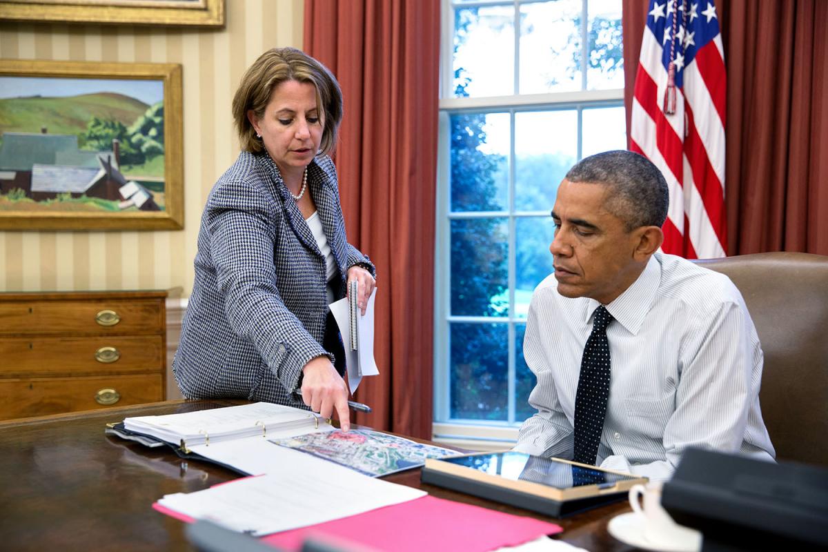 President Barack Obama is briefed by Lisa Monaco, Assistant to the President for Homeland Security and Counterterrorism, on the shooting in Canada prior to a phone call to Canadian Prime Minister Stephen Harper, Oct. 22, 2014.