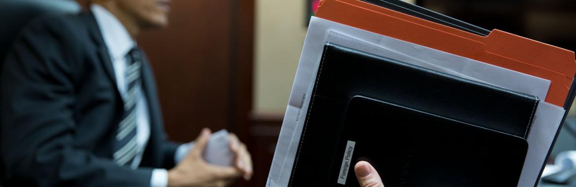 Vice President Joe Biden holds a briefing book and assorted folder at the conclusion of a meeting in the Situation Room.