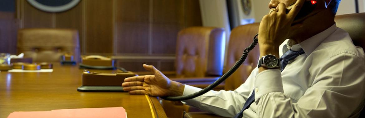 President Barack Obama talks on the phone with French President François Hollande from aboard Air Force One, Jan. 7, 2015.