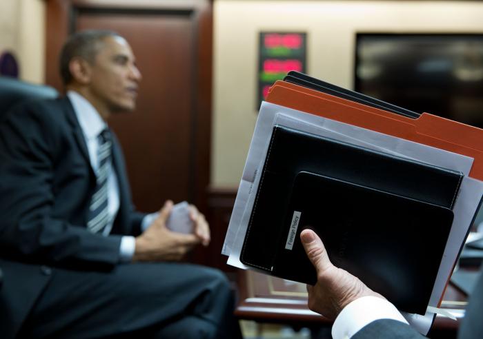 Vice President Joe Biden holds a briefing book and assorted folder at the conclusion of a meeting in the Situation Room.