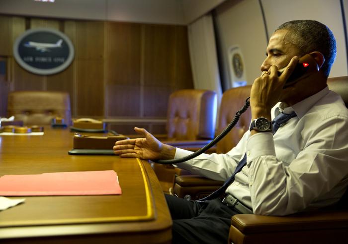 President Barack Obama talks on the phone with French President François Hollande from aboard Air Force One, Jan. 7, 2015.