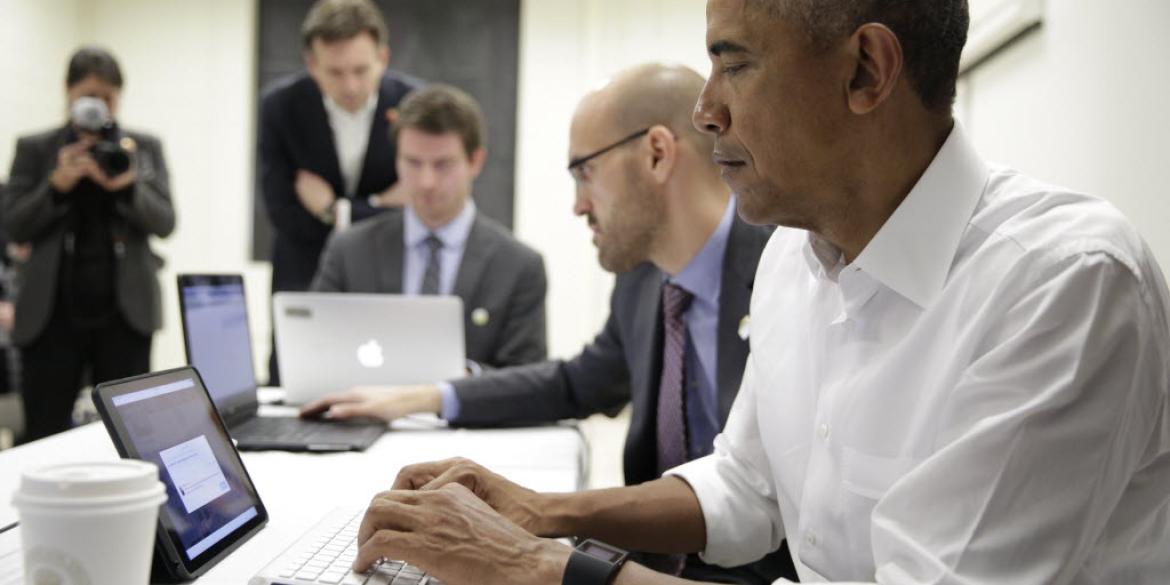 President Barack Obama typing on a tablet participating in a Twitter Q&A at McKinley High School in Baton Rouge, La.