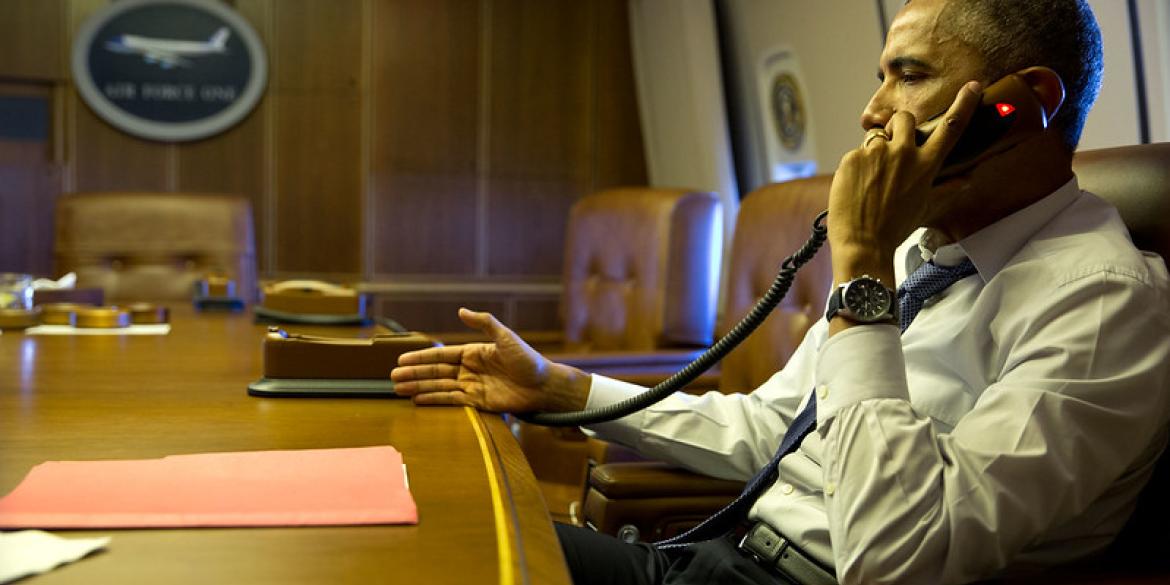 President Barack Obama talks on the phone with French President François Hollande from aboard Air Force One, Jan. 7, 2015.
