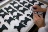 White House pastry chefs decorate cookies shaped like Bo, the Obama family dog, for holiday receptions at the White House, December 8, 2010.