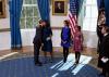 President Barack Obama and First Lady Michelle Obama embrace following the official swearing-in ceremony in the Blue Room of the White House on Inauguration Day, January 20, 2013. Standing, from left, are daughters Malia and Sasha and Supreme Court Chief