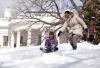 First Lady Michelle Obama with daughters, Malia and Sasha, sled in the snow on the South Lawn of the White House, March 2, 2009. 