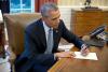 President Barack Obama signs a letter to Ileana Yarza, a 76-year-old letter writer in Cuba, in the Oval Office, March 14, 2016. 