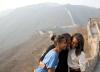 First Lady Michelle Obama hugs daughters Sasha, left, and Malia as they visit the Great Wall of China in Mutianyu, China, March 23, 2014.
