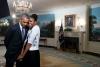 First Lady Michelle Obama snuggles against President Barack Obama before a videotaping for the 2015 World Expo, in the Diplomatic Reception Room of the White House, March 27, 2015.