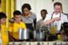 First Lady Michelle Obama and Chef Thomas Ciszak join school children in preparing the annual fall harvest meal in the East Room of the White House, October 14, 2014.