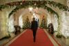 President Barack Obama walks through the Ground Floor Corridor of the White House following the Christmas Holiday General Reception #4A, December 12, 2014. 