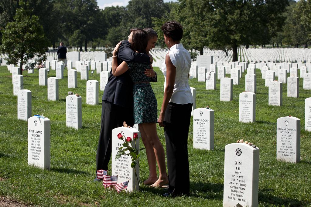 President Barack Obama hugs a woman during a visit with First Lady Michelle Obama to Section 60 of Arlington National Cemetery in Arlington, Virginia, September 10, 2011. Section 60 is reserved for military personnel who have lost their lives while fighti