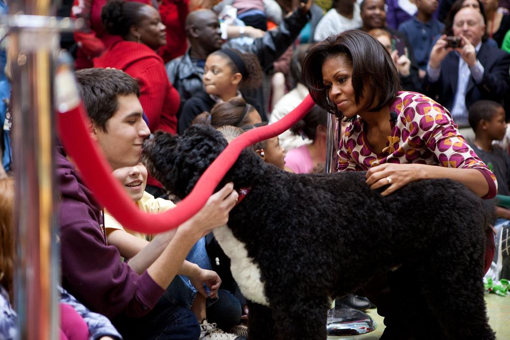 First Lady Michelle Obama and Bo, the Obama family dog, greet audience members at Children’s National Medical Center in Washington, D.C., December 12, 2011. Mrs. Obama read "Twas the Night Before Christmas" during a Christmas holiday program with children