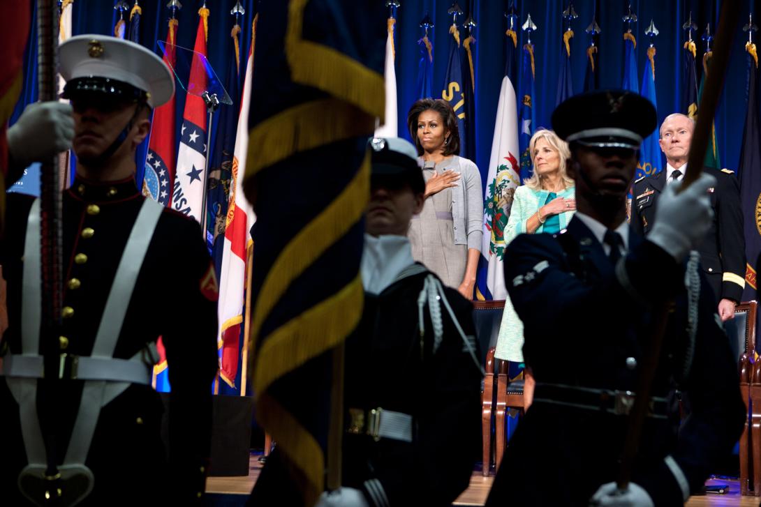 First Lady Michelle Obama, Dr. Jill Biden, and Gen. Martin Dempsey, Chairman of the Joint Chiefs of Staff, stand for the national anthem at the Pentagon in Arlington, Virginia, February 15, 2012. During the event, a report was unveiled outlining opportuni