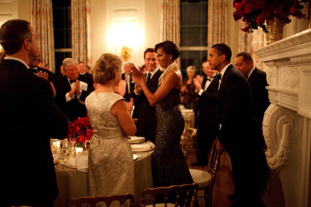 President Barack Obama pulls out the chair for First Lady Michelle Obama at the Governors Ball in the State Dining Room of the White House, February 22, 2009.