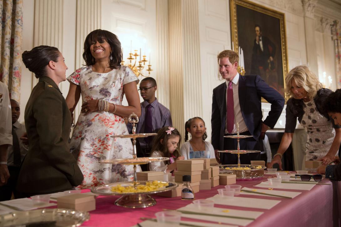 First Lady Michelle Obama, Prince Harry of Wales, and Dr. Jill Biden help military children create Mother's Day cards and other crafts in the State Dining Room of the White House, May 9, 2013. The children presented the gifts to their moms during the Join