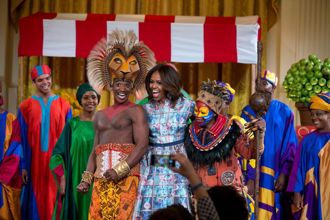 First Lady Michelle Obama joins the cast of Disney's "The Lion King" onstage after their performance at the Kids' State Dinner in the East Room of the White House, July 18, 2014. 