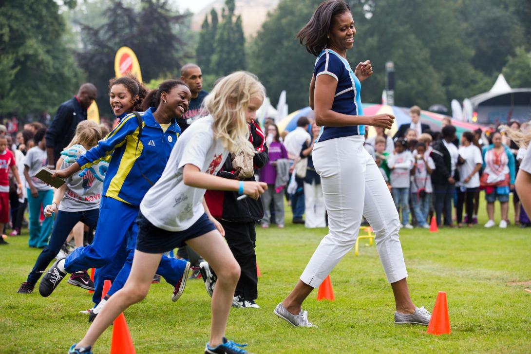 First Lady Michelle Obama runs at an activity station during a "Let's Move! London" event at Winfield House in London, England, July 27, 2012.