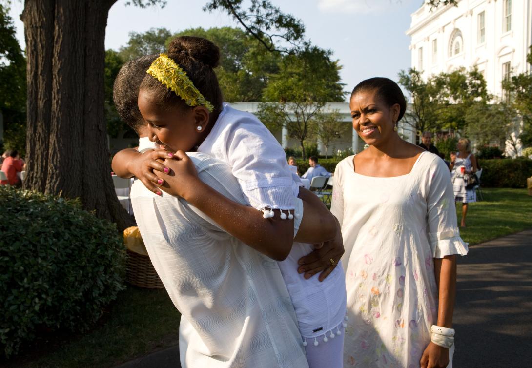 President Barack Obama greets First Lady Michelle Obama and daughter Sasha upon their arrival at a barbecue in celebration of his 49th birthday on the South Lawn of the White House, August 8, 2010