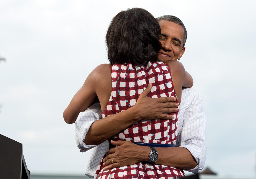 President Barack Obama hugs First Lady Michelle Obama after she introduces him at a grassroots campaign event at Lagomarcino's Confectionary in Davenport, Iowa, August 15, 2012. 