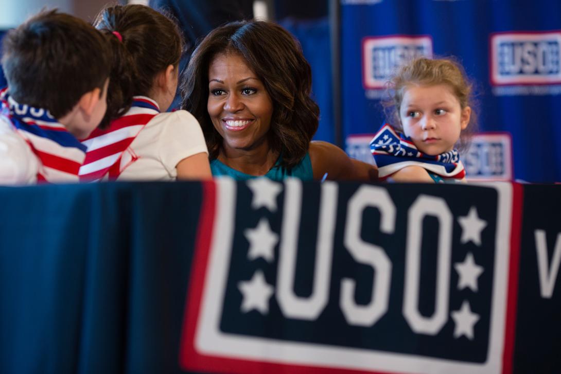 First Lady Michelle Obama talks with children at the USO Warrior and Family Center in Fort Belvoir, Virginia, September 11, 2013. The center supports wounded, ill, and injured troops, their families, and caregivers, as well as local active duty troops.