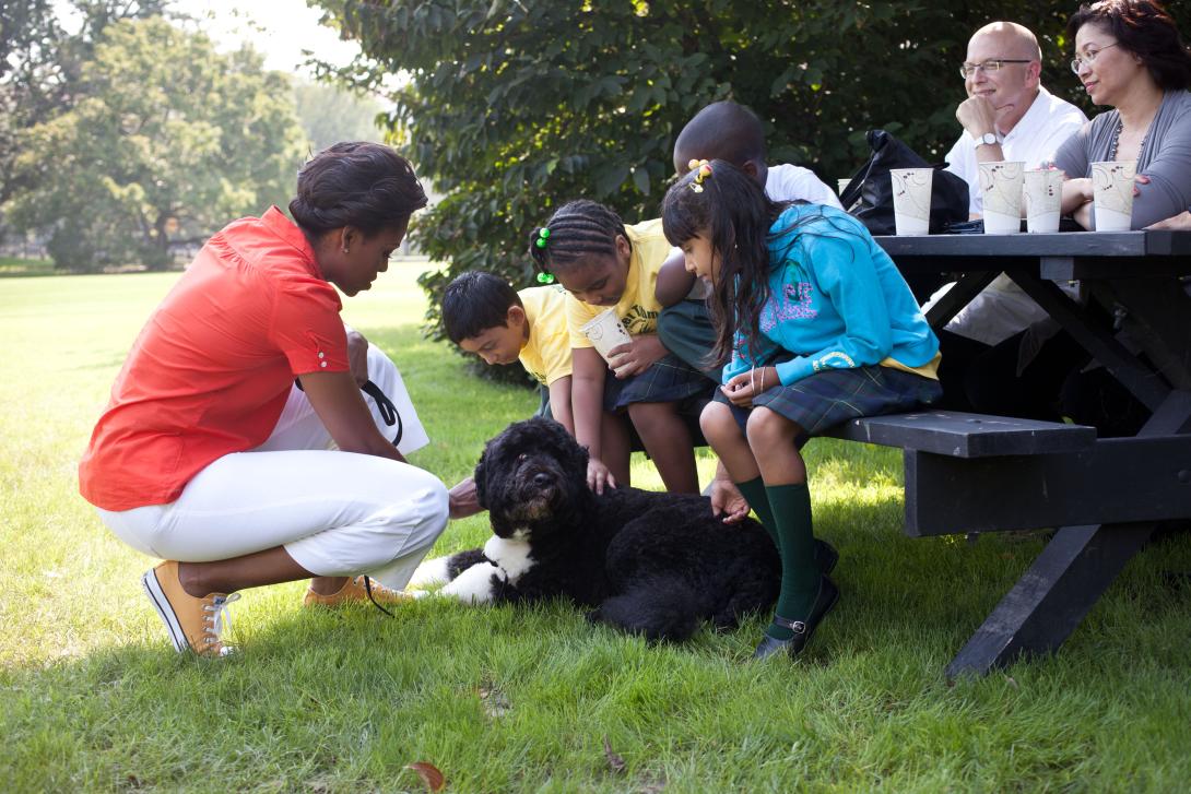 First Lady Michelle Obama and kids from Tubman Elementary School in Washington, D.C., pet Bo, the Obama family dog, on the South Lawn of the White House, September 14, 2011. 