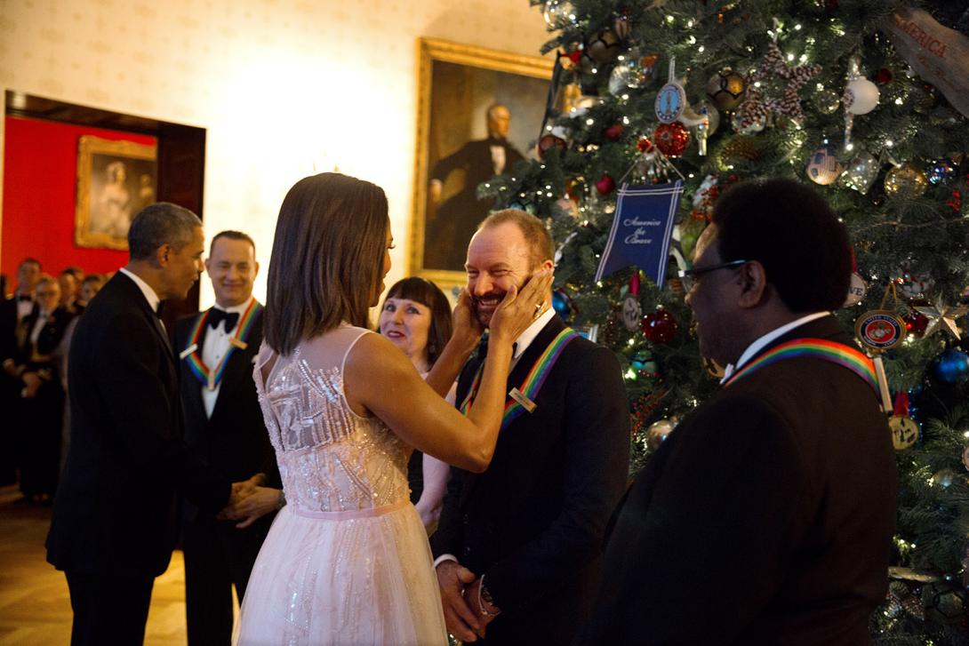 First Lady Michelle Obama greets Sting while President Barack Obama greets other honorees Tom Hanks, Lily Tomlin, and Patricia McBride in the Blue Room during the Kennedy Center Honors reception at the White House, December 7, 2014. Honoree Al Green stand