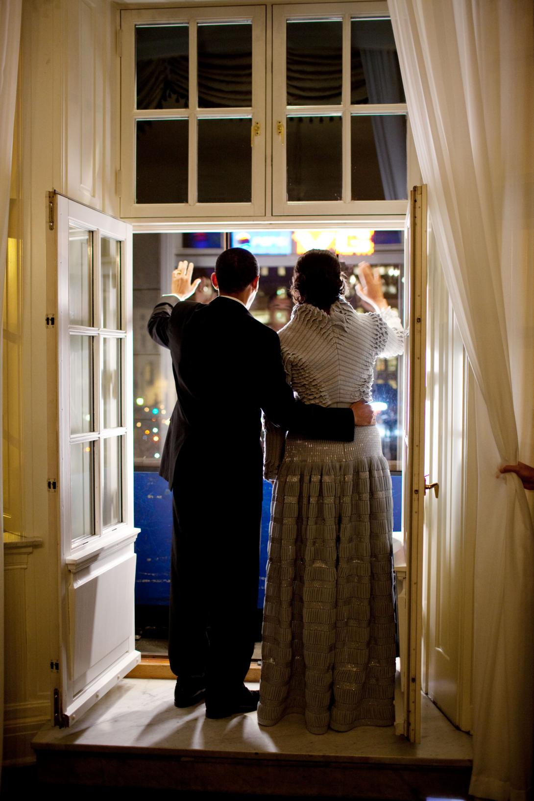 President Barack Obama and First Lady Michelle Obama wave from a balcony at the Grand Hotel as they greet the Torch Parade in Oslo, Norway, December 10, 2009.