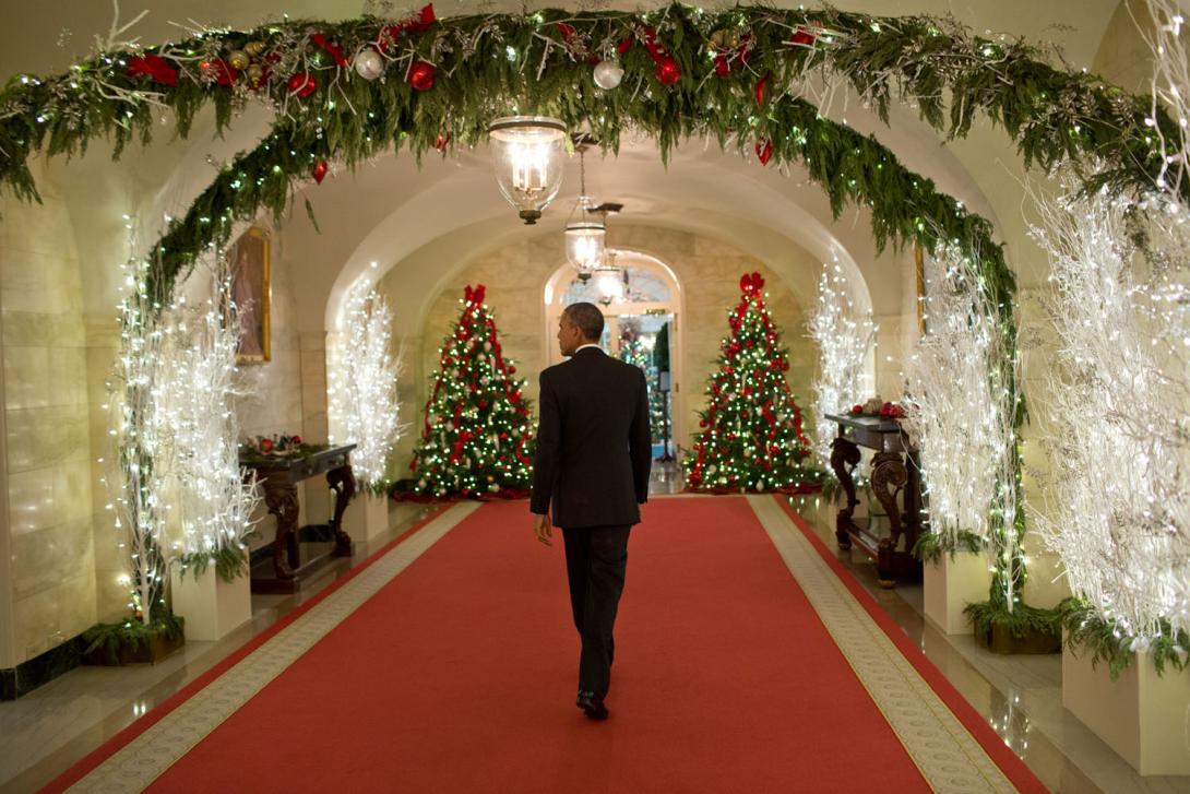 President Barack Obama walks through the Ground Floor Corridor of the White House following the Christmas Holiday General Reception #4A, December 12, 2014. 